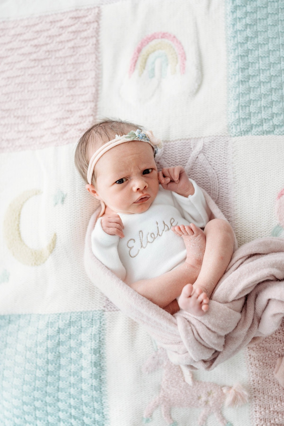 Newborn wearing a handmade personalised romper by Sweet Sews by Ann